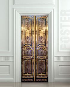 an open door in a white room with gold trimmings on the front and side