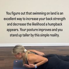 a woman is doing yoga on the floor in front of a wall with an inspirational quote