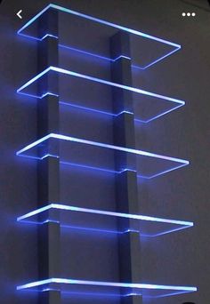 a tall building with blue lights on it's sides