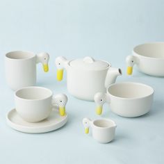 white porcelain dishes and cups with yellow ducks on them