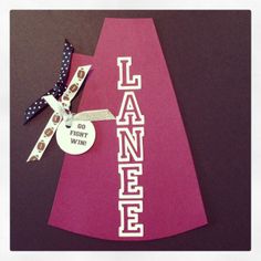 a pink piece of paper with a lanyard tag attached to it on a table