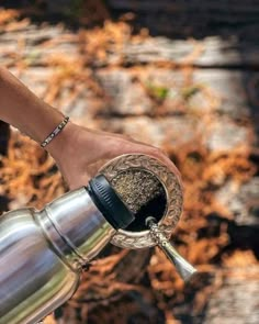 a person holding a coffee pot filled with ground