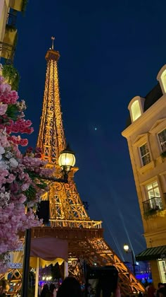 the eiffel tower is lit up at night