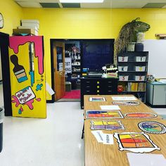 an empty classroom with desks, refrigerator and other items on the table in front of it