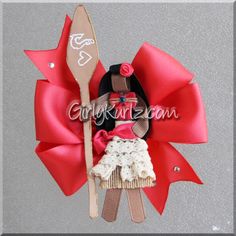 a red bow with a doll holding a fork