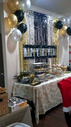 a table with balloons, plates and silverware on it