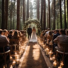 the bride and groom are walking down the aisle at their wedding ceremony in the woods