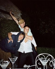 three men are posing for the camera at a party