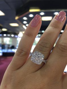 a woman's hand with a diamond ring on it