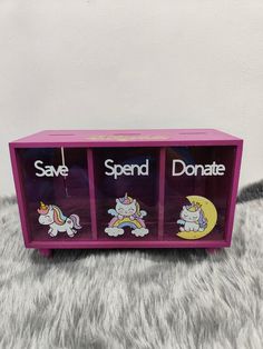 a pink wooden toy box with unicorns on it and the words spend, don't