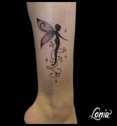 a woman's leg with a tattoo on it that has a fairy sitting on top of