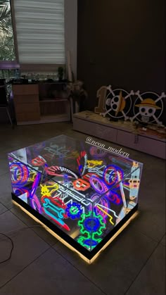 a glass table that has been lit up with neon letters and numbers on the surface