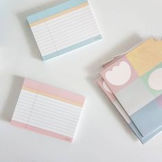 three notepads sitting next to each other on top of a white countertop