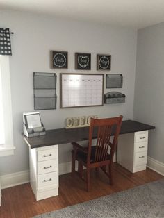 a desk and chair in a room with two pictures on the wall above it that says 2013