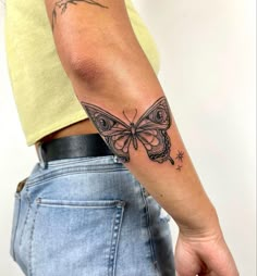 a person with a butterfly tattoo on their arm