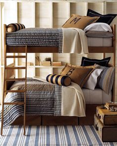 a bedroom with bunk beds and striped rugs