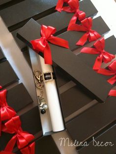 an open gift box with red ribbon on it and a keychain in the middle