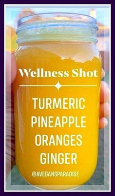 a person holding up a jar of orange juice with the words,'wellness shot turmetic pineapple orange ginger '