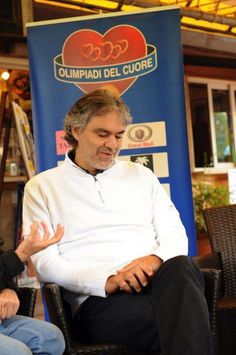 a man sitting in a chair talking to someone