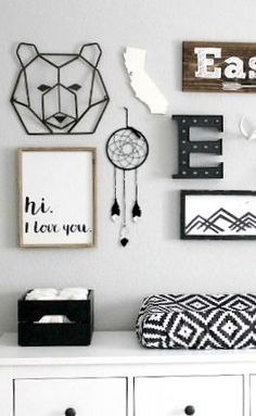 a white dresser sitting next to a wall with pictures and other items on top of it