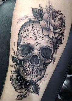 a skull with roses on it's head is shown in black and grey ink