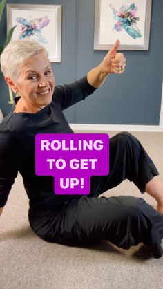 an older woman sitting on the floor with her thumbs up and text reading rolling to get up