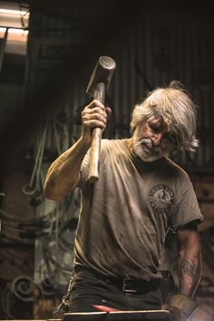 a man holding a hammer in his right hand