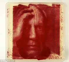 a red and white photo of a woman's face on a square plate with dots