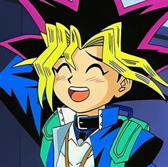 a cartoon character with blonde hair wearing a blue and green outfit, smiling at the camera