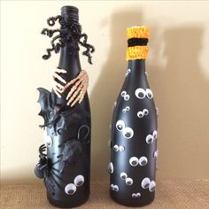 two black bottles decorated with halloween decorations