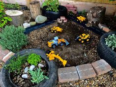 there are toy trucks and tractors in the garden