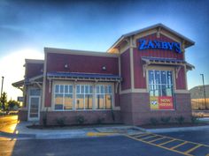 the exterior of a zaby's restaurant at sunset