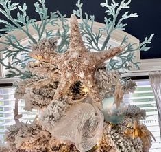 a christmas tree decorated with starfishs and seashells