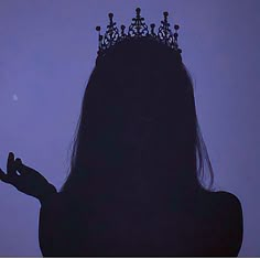 the silhouette of a woman with a crown on her head and hands in front of her face