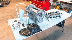 a car engine sitting on top of a table in a garage