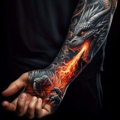 a man's arm with a dragon on it and flames coming out of his hand