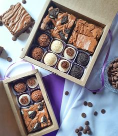 two boxes filled with different types of desserts