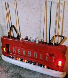 a pool table with billiards and cues on it in the shape of a chevrolet truck