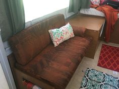 a futon couch sitting in front of a window