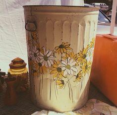 a painted trash can sitting on top of a table