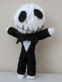 a black and white stuffed animal wearing a suit