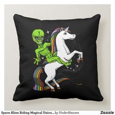 an alien riding on the back of a white unicorn pillow with text space alien riding magical unicorn by under heaven