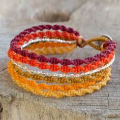 Shimmering beads of silver harmonize with shades of orange yellow red and brown in the design of this wristband bracelet. Thailand's Napapat crafts her design by hand with macrame techniques resulting in a bracelet of wondrous allure. .950 Silver Bracelet Patterns Easy, String Bracelet Patterns, Cute Friendship Bracelets, Friendship Bracelet Patterns Easy, Macrame Bracelet Patterns, Candy Bracelet, Bracelets To Make, Friendship Bracelets Patterns, Friendship Bracelets Tutorial