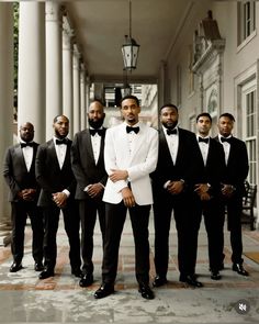 a group of men in tuxedos standing next to each other