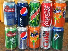 a group of soda cans sitting on top of a counter