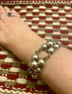 "Mexican Silver Flower Link Bracelet! Nice weight is at 26.8 grams. Wear alone or with other bracelets. Fits a wrist size up to 7\" inches. Bracelet width is 3/4\" inches. Vintage 1940s bracelet, but in very good condition. Note: I see one minor dent on one of the balls. Hallmarks are Mexico Silver. Please review all pictures.  THANK YOU for visiting my Etsy shop & don't forget to check out my other Vintage Beauties! If you like what you see, please FAVORITE MY SHOP for new listings ; ) I have e Adjustable Vintage Sterling Silver Jubilee Bracelet, Vintage Handmade Round Chain Bracelet, Handmade Vintage Round Chain Bracelet, Handmade Vintage Chain Bracelet, Vintage Hallmarked Round Chain Bracelet, Vintage Sterling Silver Jubilee Bracelet For Wedding, Vintage Sterling Silver Oyster Bracelet, Mid-century Silver Bracelet, Silver Bracelet Gift