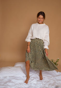 Green maxi skirt features a pleated effect in the fabric, which creates a beautiful flowy look. The skirt is also lined and has golden lurex in the pattern, giving it a touch of luxury and sparkle. It has an elastic waist for a comfortable fit, making it a versatile and practical addition to any wardrobe. Sizing runs true to size Our models wear the Ecru Joela Sweater Sizes: S-M / M-L S-M: Length 34.26 in - Width 12.6 inM-L: Length 35.04 in - Width 13.39 in Context: 100% Polyester Washing: hand Green Maxi Skirt, Thrift Inspo, Spring Photos, Photo Outfit, Mom Outfits, Winter 2024, Mom Style, Modest Outfits