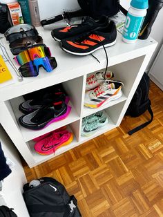 there are many pairs of shoes on the shelf next to each other in this room