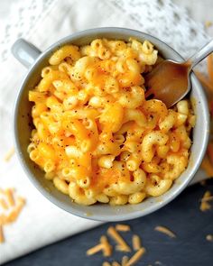 a bowl filled with macaroni and cheese on top of a table