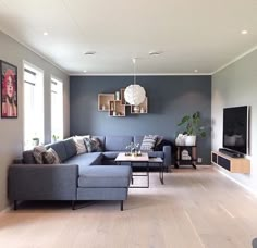 a living room filled with furniture and a flat screen tv sitting on top of a wooden floor